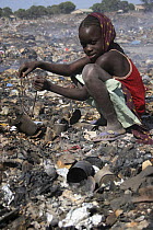 Gambian girl searching for aluminium scrap, Mannjai Kunda rubbish dump, The Gambia, 2008
