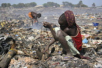 Gambian girl searching for aluminium scrap, Mannjai Kunda rubbish dump, The Gambia, 2008