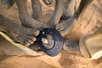 Feet touching a football made from old fabric, The Gambia, 2008