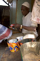 Discarded drinks cans being cut up by craftsman, Dakar, Senegal, 2008