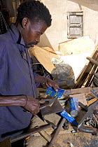 Craftsman cutting up discarded drinks cans, Dakar, Senegal, 2008