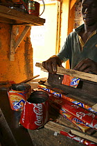 Discarded drinks cans being crafted by artisan, Dakar, Senegal, 2008