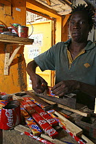 Artisan crafting a tray from discarded drinks cans, Dakar, Senegal, 2008