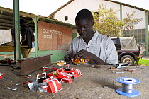 Artisan crafting toy cars from discarded cans, Dakar, Senegal, 2008