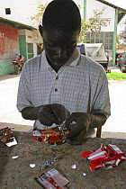 Artisan soldering toy cars, crafted from discarded cans, Dakar, Senegal, 2008