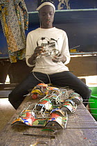 Artisan with toy cars crafted from recycled materials, Dakar, Senegal, 2008