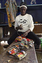Artisan with toy cars crafted from recycled materials, Dakar, Senegal, 2008
