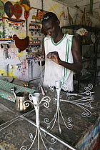 Artisan crafting candle holders from wire, Dakar, Senegal, 2008