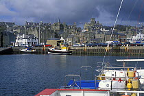 Small boat harbour overlooked by the grey-stone buildings of Lerwick, Shetland Islands, Scotland, UK