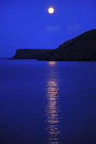 Full moon over the sea and Fetlar Island, Shetland Islands, Scotland, UK