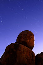 Granite boulders of Devils Marbles at night with star trails, Karlu Karlu Conservation Reserve, Northern Territory, Australia