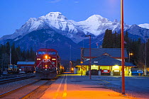 Train at station platform, Canadian Pacific Railway with Rocky mountains in the background, Banff, Alberta, Canada