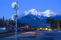 Train at station platform, Canadian Pacific Railway with Rocky mountains in the background, Banff, Alberta, Canada