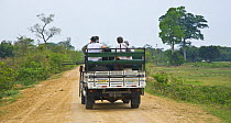 Tourists in safari jeep bird watching in the Pantanal NP, Mato Grosso, Brazil