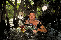 Photographer, Michel Roggo, working in the flooded forest, Rio Tabajos, Amazon, Brazil.