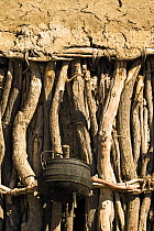 Himba people, close up of tradtional wooden and mud hut with cooking pot, Skeleton Coast, Namibia