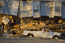 Damage caused to house, car and street by Hurricane Katrina, on the shore of Lake Pontchartrain, Slidell, Louisiana, USA, August 2005