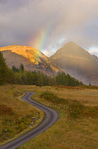 Mountain road with rainbow in Glen Etive, Argyll, Scotland, UK, October 2007