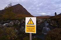 Spoof risk sign in front of Buachaille Etive Mor, Argyll, Scotland, UK, October 2007