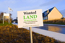 Spoof "Land Wanted for growing food" sign near housing development, Angus, Scotland, UK, 2007
