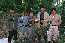 Hornbill research team led by Dr. Pilai Poonswad hold a captured Rufous-necked Hornbill (Aceros nipalensis). Huai Kha Khaeng Wildlife Refuge, Thailand, 1998. IUCN Vulnerable