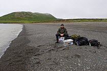 Wildlife Photographer, Ingo Arndt, with equipment, heading for Round Island, Bering Sea, Bristol Bay, Alaska, 2008