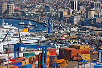Containers, cranes and ships against a city backdrop. Port of Valparaiso, Chile, 2008.