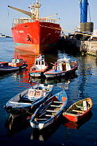 Small open boats with busy port behind. Valparaiso, Chile 2008.