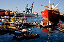 Passenger ferries, open-boats and container ships in the port of Valparaiso, Chile 2008.