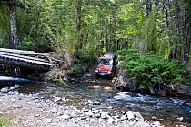 Four wheel drive vehicle entering a river in the Lakes region of central Chile, 2008.