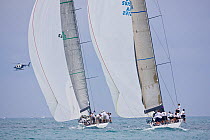 Four yachts racing under spinnaker, with helicopter nearby, during the Acura Miami Grand Prix, Florida, USA. March 2008