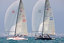 Two yachts close racing during the Acura Miami Grand Prix, with city visible behind. Florida, USA. March 2008