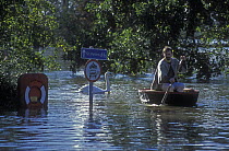 Man in coracle on flooded River Severn, Worcester, Worcestershire, UK, November 2000