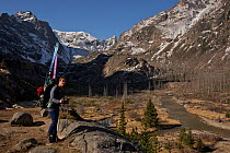 Skier Phil Atkinson hikes up the East Rosebud Creek Trail into the Beartooth Mountains, Montana, USA May 2008