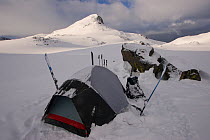 Skier camping near Sky Top Lakes, on the approach to Granite Peak, Beartooth Mountains, Montana, USA. May 2008