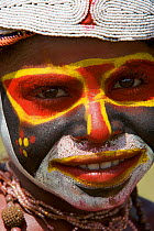 Villager in traditional costume with painted face at Goroka Cultural Show in the Eastern Highlands Province, Papua New Guinea. September 2004