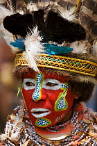 Villager in traditional costume with painted face at Goroka Cultural Show in the Eastern Highlands Province, Papua New Guinea. September 2004
