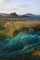 Fishing nets beside the footpath at Pernagie, St. Martin's, looking towards the Round Island Lighthouse. December 2008.