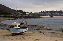 Fishing boat at low tide on New Grimsby Beach, Tresco, Isles of Scilly. December 2008.