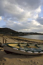 Rowing boat pulled up on New Grimsby Beach, Tresco, Isles of Scilly. December 2008.