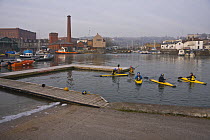 Kayakers at Underfall Yard on the floating harbour, frozen over in January 2009. Bristol, UK.