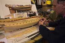 Malcolm Darch working on HMS "Minerva" (circa 1780) model in his workshop. Salcombe, Devon, UK. January 2009.