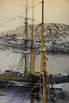 Close up of mast of 'Salcombe fruiter' schooner "Brizo" model made by Malcolm Darch, against old photograph of the ship, in Malcolm's workshop. Salcombe, Devon, UK. January 2009.