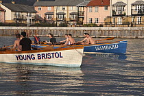 Men's crews practicing in pilot gigs "Isambard" and "Young Bristol" on Bristol Floating Harbour in the morning. February 2009.