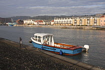 Harbour Master's boat refueling on Bristol Floating Harbour in the morning. February 2009.