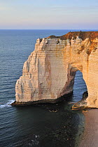 Manne Porte at sunset, a natural arch in the chalk cliffs at Etretat, Normandy, France