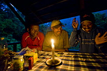 The guides and porters playing a traditional game in Camp 2, Marojejy National Park, after work monitoring endangered Silky sifakas.