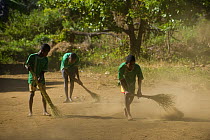 Children sweeping playground at school, Mahamasina Village, North Ambilobe, Ankarana Special Reserve, North Madagascar.