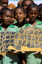 Children with tortoise images singing at a party to celebrate the 5th of June, World Environment Day, Manerinerina, Majunga, Madagascar.