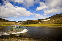 Crossing river with a Land Rover, Landmannalaugar mountains, central Iceland. July 2008